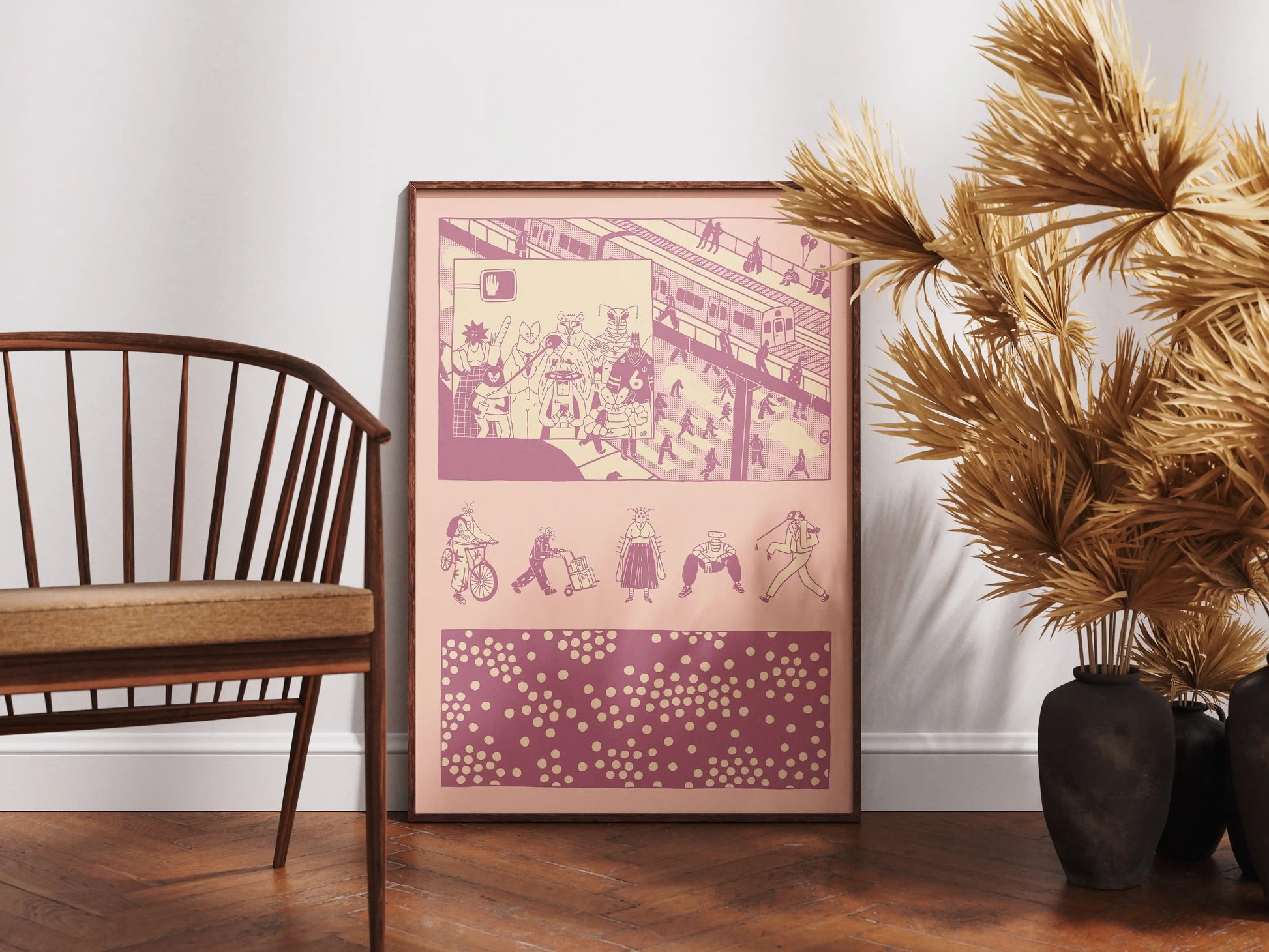 Framed ‘Bug Vision’ city illustration poster by NYC artist Max Kolo displayed on a hardwood floor beside a wooden chair and tall golden dried plants, featuring stylized insect characters commuting through a bustling urban scene in pink and purple graphic panels.