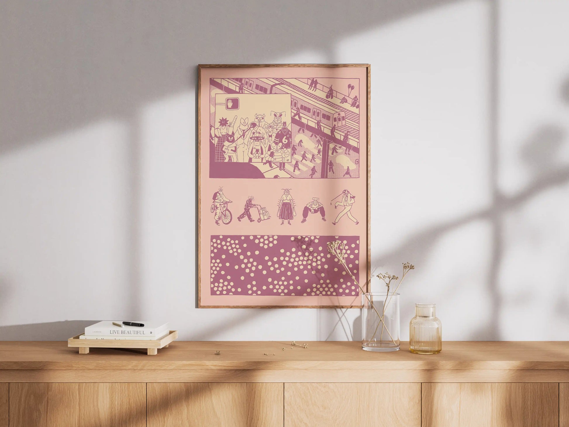 Framed ‘Bug Vision’ city illustration poster by NYC artist Max Kolo displayed on a wooden sideboard in soft natural light, featuring stylized insect characters navigating a busy urban scene in bold pink and purple graphic panels.
