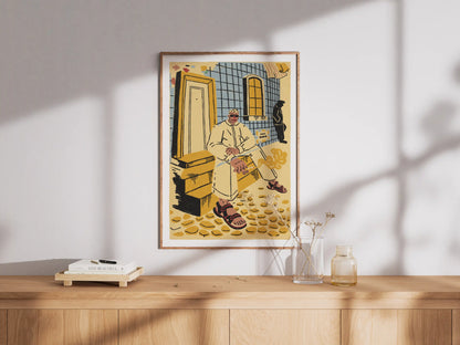 Framed ‘Lisbon’ city illustration poster by NYC artist Max Kolo displayed on a wooden sideboard with soft window light, featuring a stylized Lisbon man sitting on sunlit tiled steps in warm yellow and blue tones.