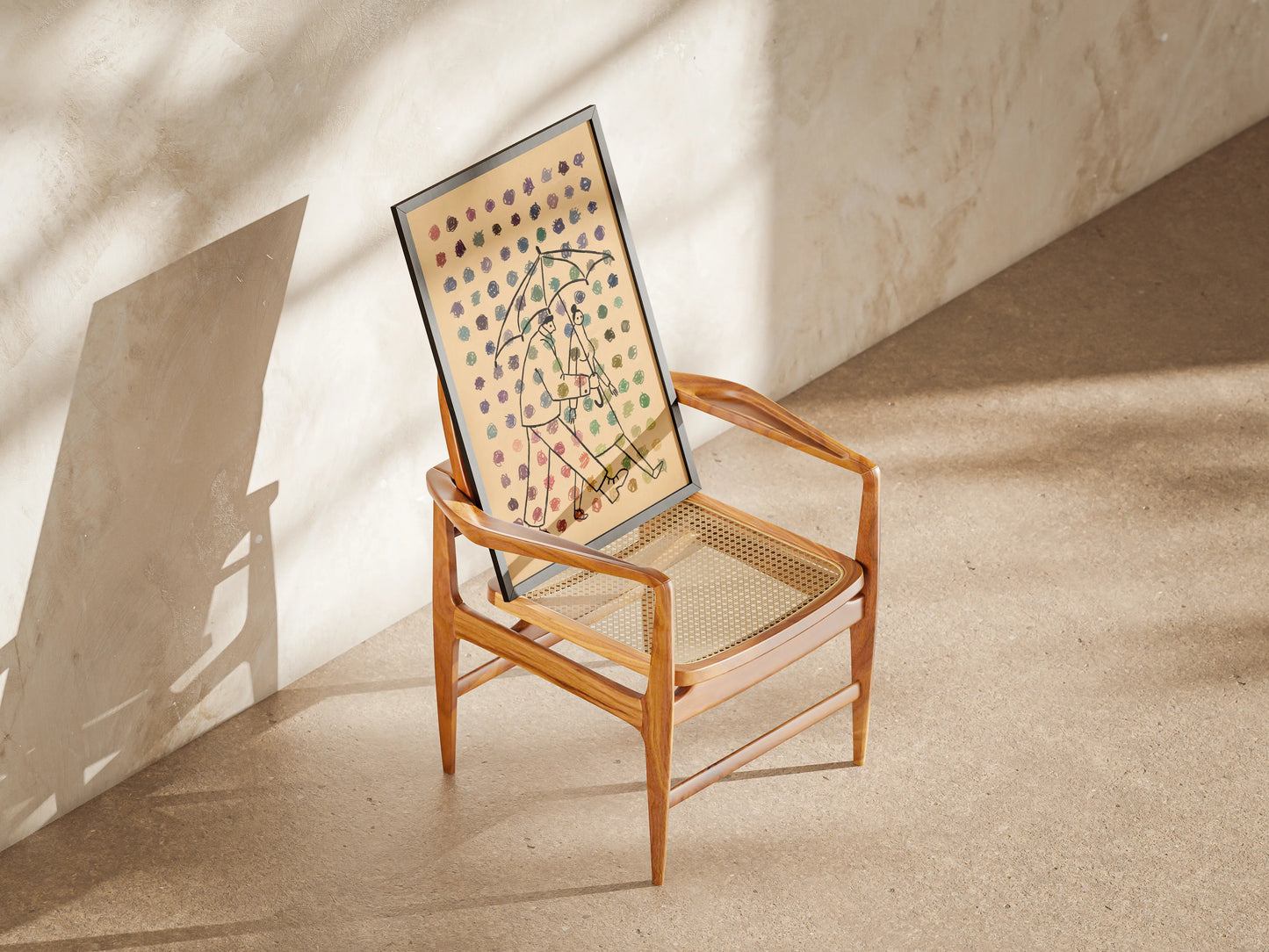 Wooden chair with a framed artwork on a beige floor and wall. Artwork of two people under an umbrella with dots of multiple colors in the foreground. Artwork by New York City Artist Max Kolo.