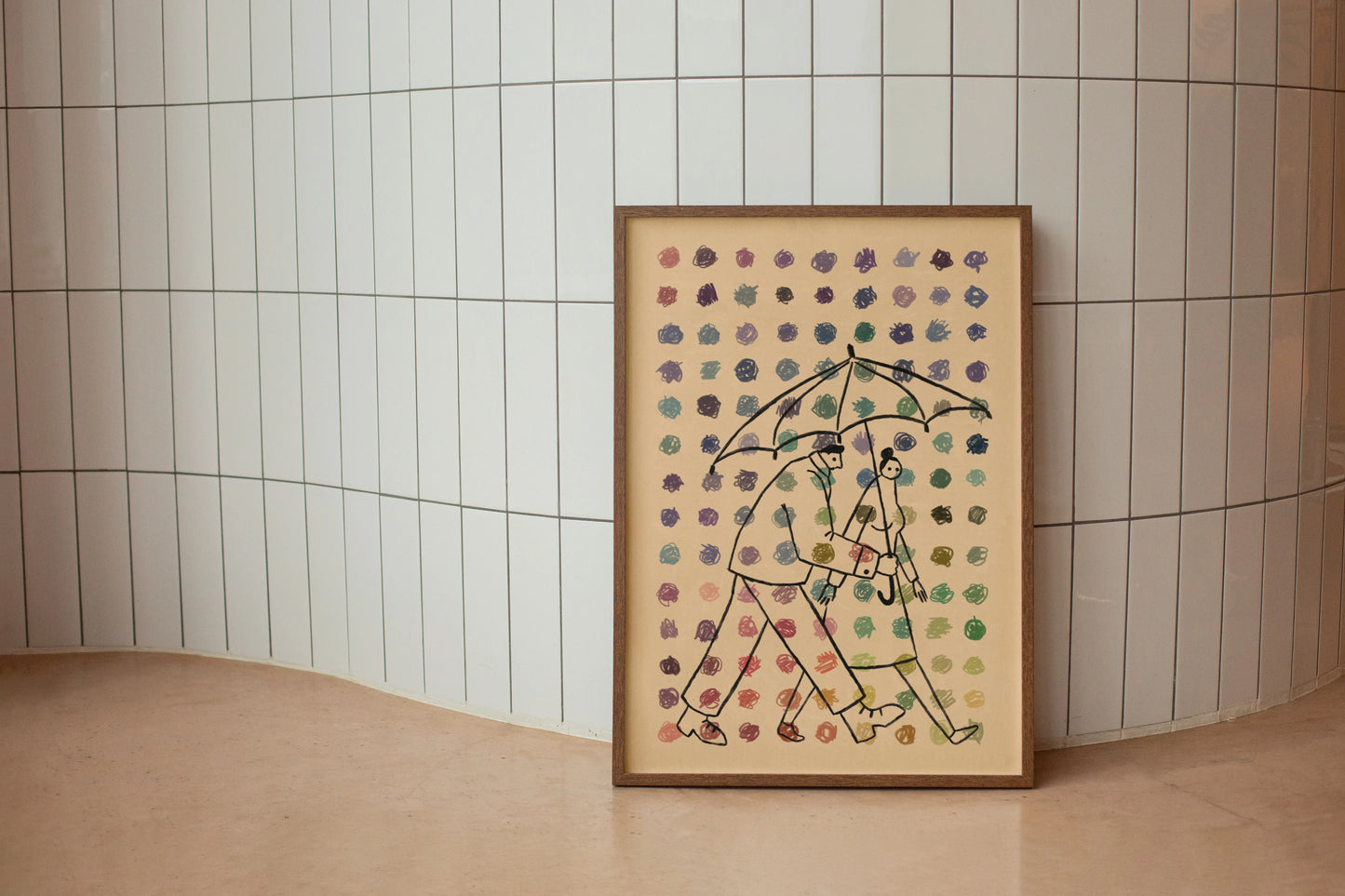Framed artwork of two people under an umbrella with a patterned background and dots of multiple colors in the foreground set against a tiled wall. Artwork by New York City Artist Max Kolo.